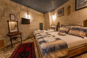 Ένα ή περισσότερα κρεβάτια σε δωμάτιο στο Goreme Mansion