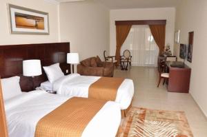 Postel nebo postele na pokoji v ubytování Akas-Inn Hotel Apartment
