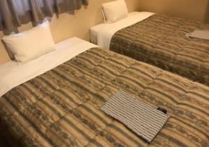 Postel nebo postele na pokoji v ubytování Business Hotel Goi Hills
