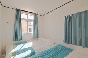 Ein Bett oder Betten in einem Zimmer der Unterkunft V.Close to Nishi-Shinjuku/FrWIF/ Roof top Terrace