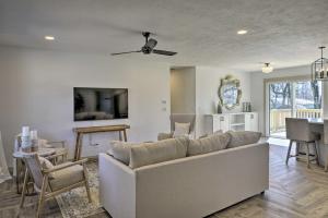 a living room with a couch and a table at Retreat with Deck about 9 Mi to Downtown Springfield in Ozark