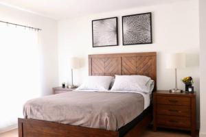 a bedroom with a bed with two night stands and two lamps at HEART OF WEST HOLLYWOOD MODERN SUITE 2 BEDROOM 2 BATH in Los Angeles