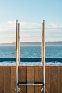 a view of a swimming pool from a window with the ocean at Les Bords De Mer in Marseille