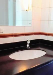 a bathroom with a sink and a mirror at OCEANPEARL 209 in Strand +12 photos