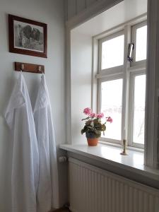 a bathroom with a window and a white towel at Guesthouse Gamli Bær in Húsafell