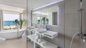 a bathroom with two sinks and a tub and a mirror at The Hype Beachhouse in Playa de Palma +37 photos