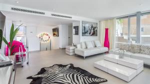 a living room with white furniture and a zebra rug at The Hype Beachhouse in Playa de Palma