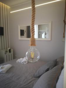 ナポリにあるSpiderRoomsのベッドに掛け掛け縄の花瓶