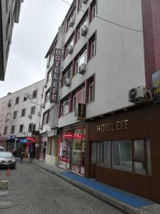 a building on a street with a hotel at Hotel Efe in Trabzon