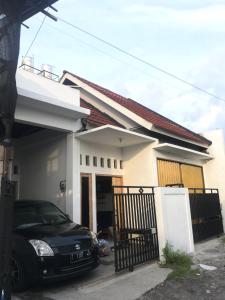 a black car parked in front of a house at The G House Ambarrukmo in Bantul