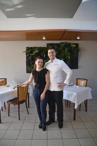 a man and a woman posing for a picture in a restaurant at La Route d'Argent in Bozouls