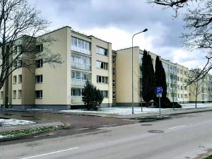 an empty street in front of a large building at Irene apartments in Druskininkai