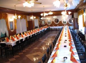 a large banquet hall with long tables and chairs at Gostišče Trobej in Gornji Grad