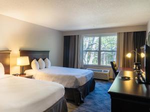 a hotel room with two beds and a window at Country Inn & Suites by Radisson, Doswell Kings Dominion , VA in Doswell +35 photos