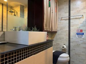 a bathroom with a sink and a toilet at Chill Chill at Nimman in Chiang Mai +40 photos
