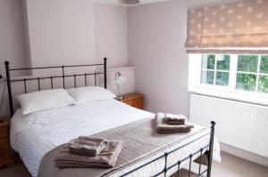 1 dormitorio con 1 cama con toallas en Pleasance Farm B&B, en Kenilworth