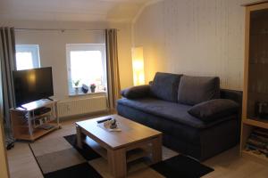 a living room with a couch and a coffee table at Friesenstube in Schweiburg