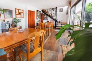 a dining room with wooden tables and chairs at AtSupers Accommodation in Jeffreys Bay