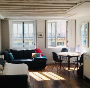 a living room with a couch and a table at Chez Vous ST HONORÉ in Paris