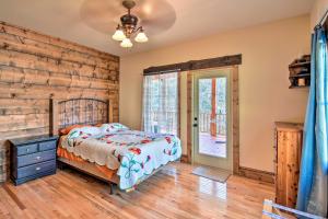 a bedroom with a bed and a wooden wall at Avalon Woods Riverfront Retreat Walk to Waterfall in Marble