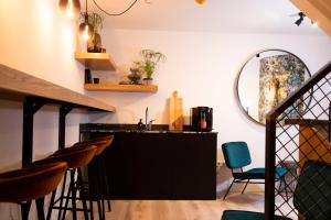 a bar in a room with chairs and a mirror at Hotel Haverkist in Den Bosch