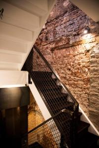 
a stone wall with a staircase leading up to it at Hotel Haverkist in Den Bosch
