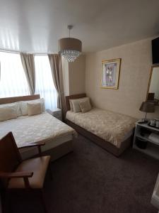 a hotel room with two beds and a desk at The Stafford in Blackpool