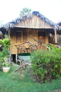 een kleine hut met een bankje ervoor bij Nature Beach Huts in Trincomalee