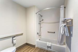 a bathroom with a shower and a toilet at Quality Inn Murfreesboro-University Area in Murfreesboro +23 photos