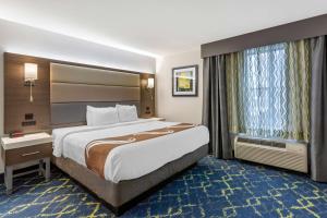 a hotel room with a large bed and a window at Quality Inn Murfreesboro-University Area in Murfreesboro