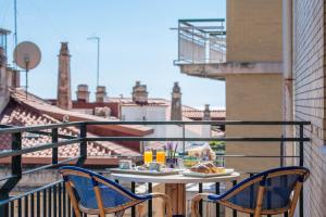 a table with food on top of a balcony at La Casa Delle Stelle in Maiori
