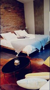 a bedroom with two beds and a coffee table at Le Loft in Aulnay-sous-Bois