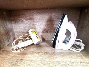 a box with a knife and a cord on a table at A's House i-City 1-4pax Studio Netflix Wifi in Shah Alam
