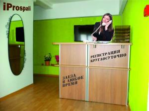 a woman standing at a podium in a room with a mirror at Economy Hotel iProspali on Kurskaya in Moscow