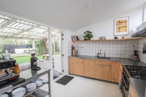 a kitchen with a sink and a counter top at Vakantiehuis Drie Dennen in Bergen