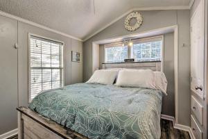 a bedroom with a bed and two windows at Bright Miramar Tropical Cabana, 2 Blocks to Beach! in Destin