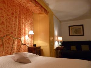 ディナンにあるChambres d'hôtes Logis Du Jerzualのベッドと椅子付きのホテルルーム