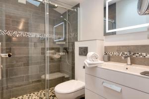 a bathroom with a shower and a toilet and a sink at Maison Amande in La Flotte +4 photos