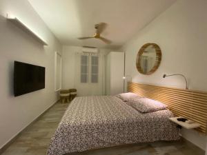a bedroom with a bed and a flat screen tv at La Bo-Aime in Orient Bay +19 photos