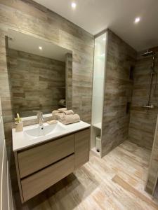 a bathroom with a sink and a shower at La Bo-Aime in Orient Bay