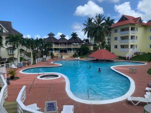 a large swimming pool in front of a hotel at Poolside Mystic Apt 9A in Ocho Rios