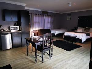 a room with a table and a bedroom with a bed at The Green Olive Guesthouse in Bethlehem