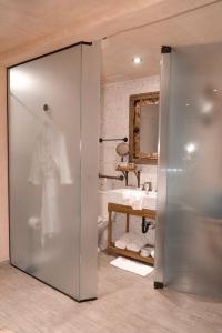 a bathroom with a tub and a shower stall at O:Live Boutique Hotel, A Small Luxury Hotel of the World in San Juan