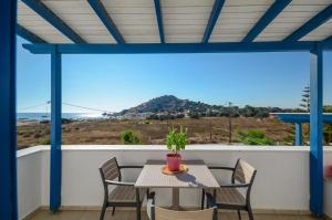 a table and chairs on a balcony with a view of the ocean at Crystal Naxos 1 Studios at Mikri Vigla in Mikri Vigla