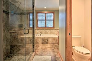a bathroom with a shower and a tub and a toilet at Lakefront Giants Ridge Retreat Near Ski and Golf! in Biwabik +35 photos