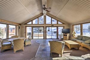 a living room with a couch and a table and chairs at Steamboat Ski Getaway with Balcony and Resort Views! in Steamboat Springs