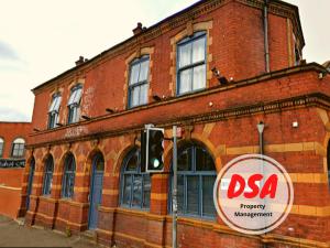 a red brick building with a dsa sign on it at Birmingham Central Station Apartment (Studio 3) in Birmingham