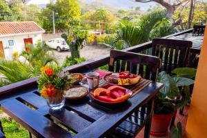 a wooden table with a plate of food on it at Rual's Hotel in Somoto