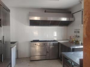 a kitchen with a stainless steel stove top oven at Albergue Cilleruelo de Bezana in Cilleruelo de Bezana