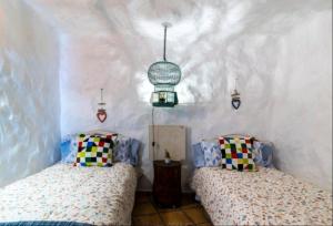 A bed or beds in a room at Silence's Cave Rural House